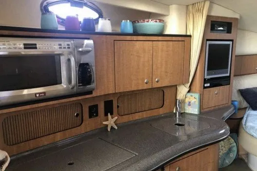 Slide: The Image of 2006 Sea Ray Sundancer 320 interior kitchen with microwave, cabinets, and sink. - 14