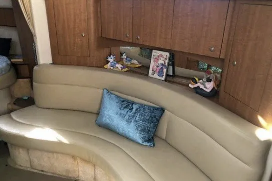 Slide: The Image of Luxurious interior of 2006 Sea Ray Sundancer 320 with curved seating and decorative accents. - 13