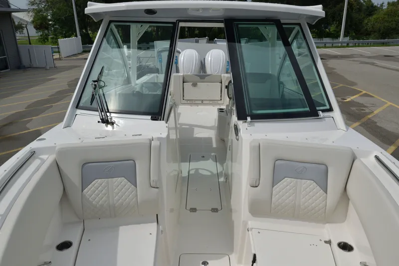 Slide: The Image of 2027 Sailfish 316 DC boat interior with cushioned seating and glass windshield. - 23