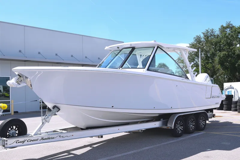 The Image of 2027 Sailfish 316 DC boat on trailer, parked outdoors, showcasing sleek design and modern features. - 0