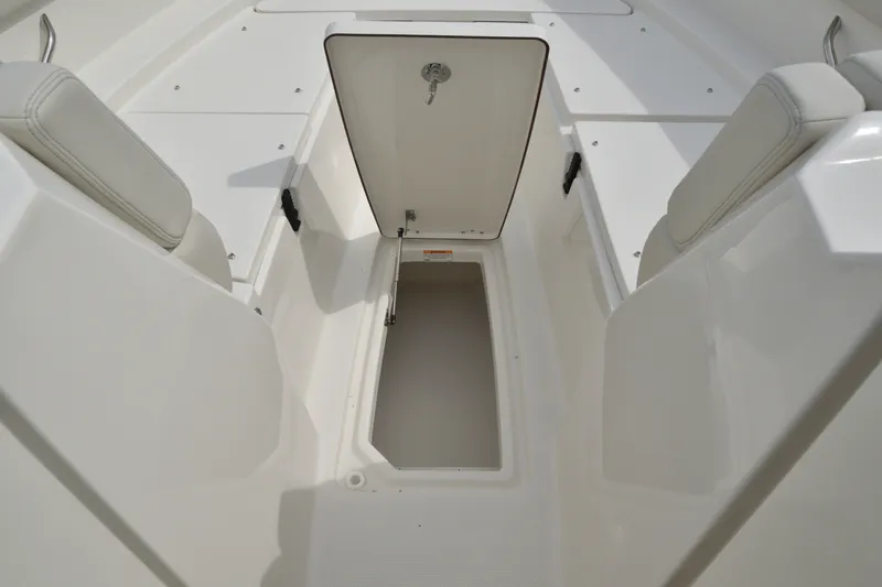 Slide: The Image of 2027 Sailfish 316 DC boat interior storage compartment with open hatch. - 26