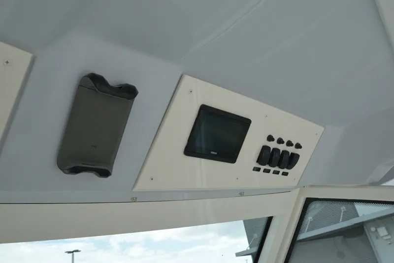Slide: The Image of Control panel of 2027 Sailfish 316 DC boat with switches and display screen. - 17