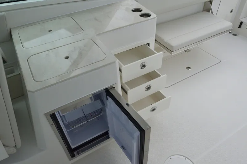 Slide: The Image of Interior of 2027 Sailfish 316 DC boat with open drawers and fridge. - 13