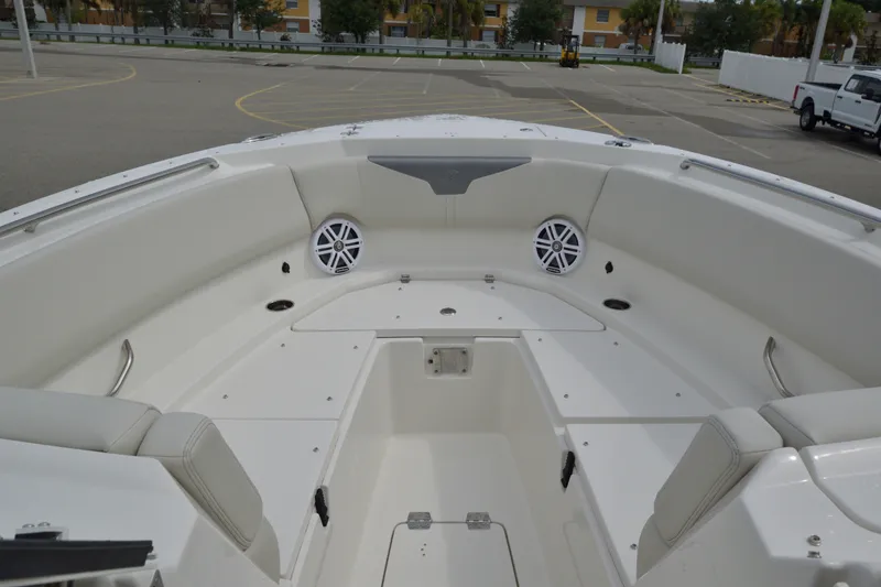 Slide: The Image of Bow seating area of 2027 Sailfish 316 DC boat with speakers and cup holders. - 21
