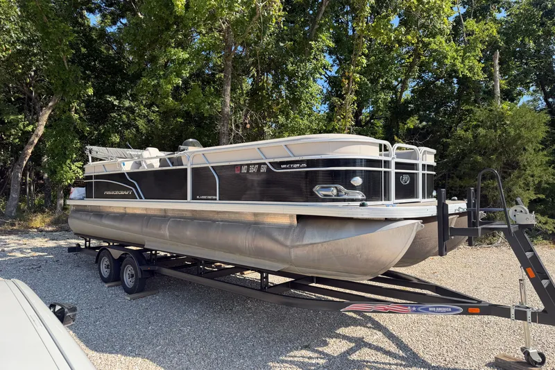 Slide: The Image of 2019 Princecraft Vectra 25 pontoon boat on trailer, parked in wooded area. - 9