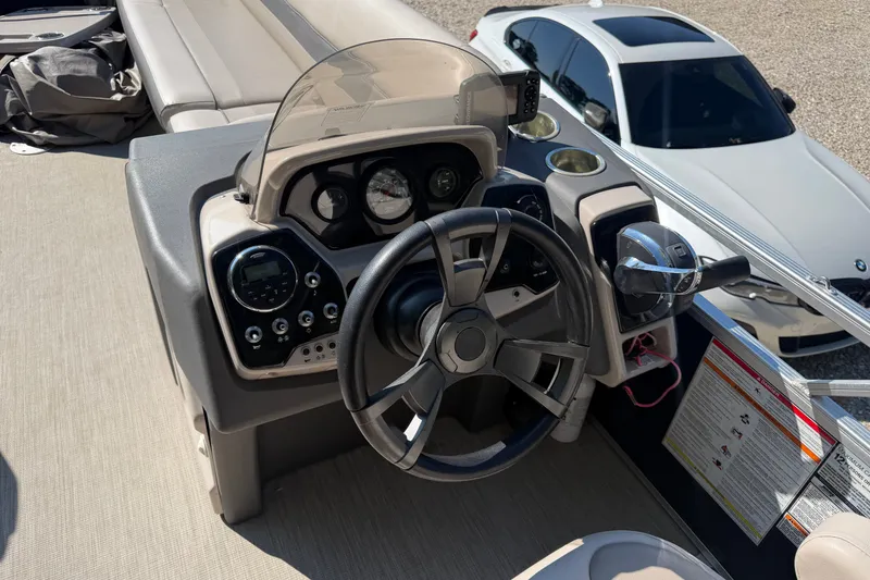 Slide: The Image of 2019 Princecraft Vectra 25 boat dashboard with steering wheel and controls. - 22