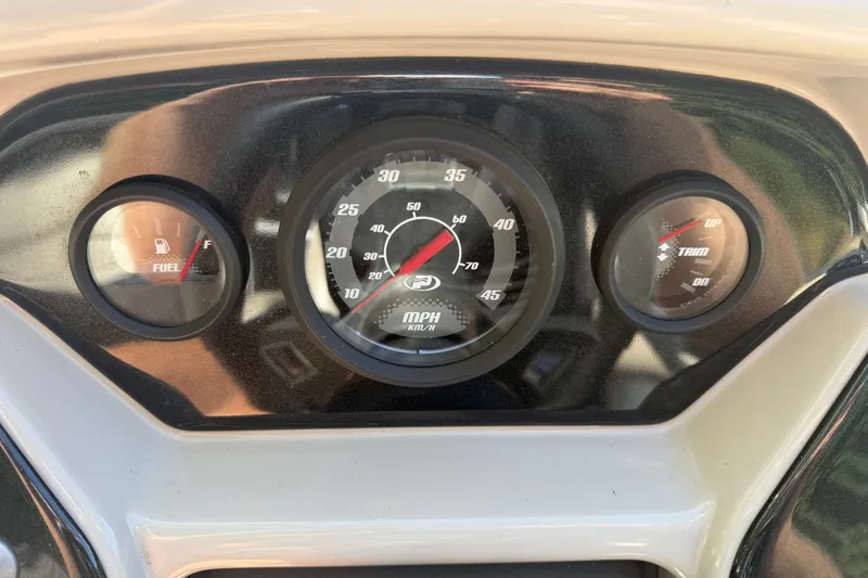 Slide: The Image of Dashboard of a 2019 Princecraft Vectra 25 boat showing fuel, speed, and trim gauges. - 25