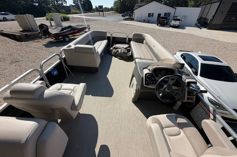 Slide: The Image of 2019 Princecraft Vectra 25 pontoon boat interior with beige seating and steering console. - 32