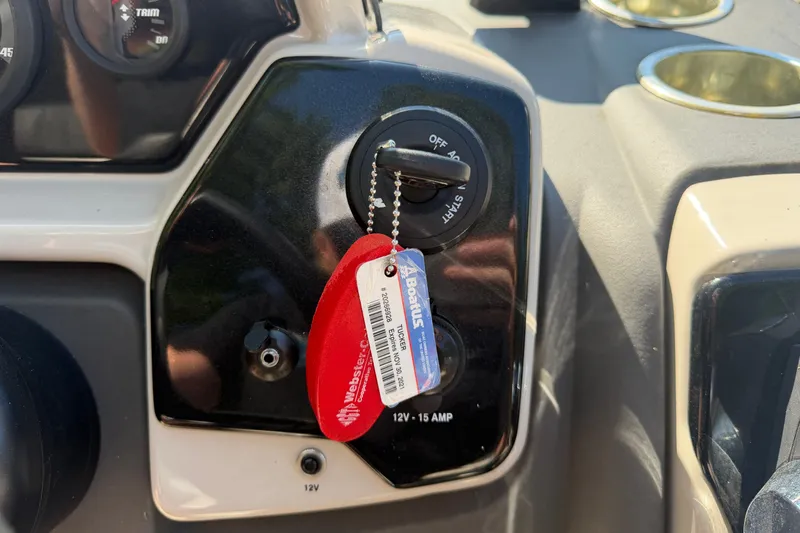 Slide: The Image of 2019 Princecraft Vectra 25 ignition with key and red tag, dashboard view. - 23