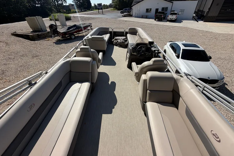 Slide: The Image of 2019 Princecraft Vectra 25 pontoon boat with spacious seating, parked near a white car. - 31