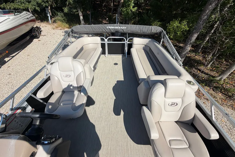 Slide: The Image of 2019 Princecraft Vectra 25 pontoon boat interior with beige seating and steering console. - 20