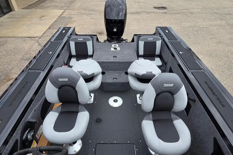 Slide: The Image of 2027 Tracker Targa V-18 Combo boat interior with four cushioned seats and storage compartments. - 14