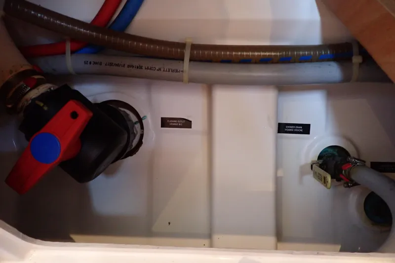 Slide: The Image of 2018 Jeanneau Sun Odyssey 389 plumbing system with labeled valves and hoses. - 174