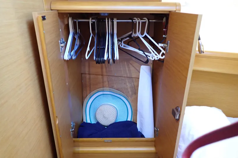 Slide: The Image of Wooden closet with hangers and a hat on Jeanneau Sun Odyssey 389, 2018 model. - 145