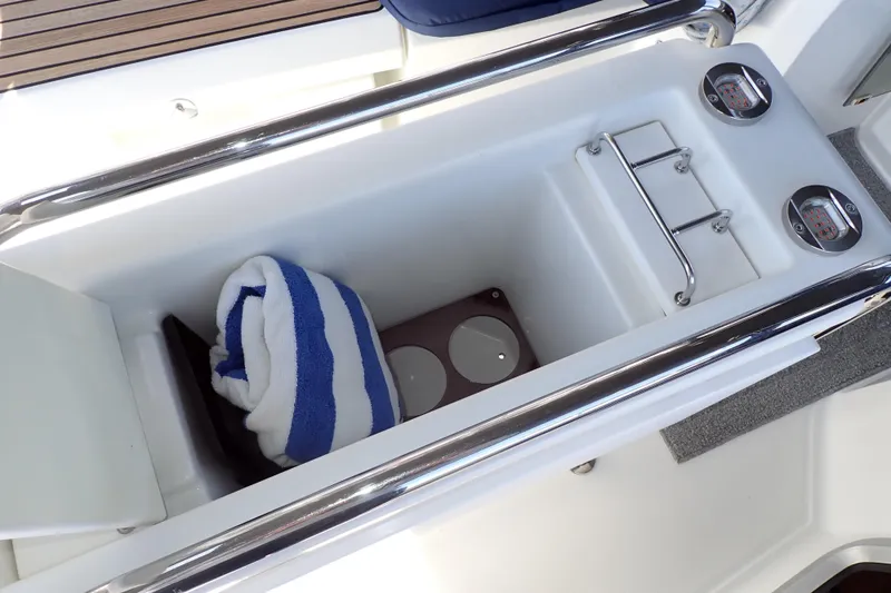 Slide: The Image of Storage compartment on 2018 Jeanneau Sun Odyssey 389 yacht with towel and gauges. - 87