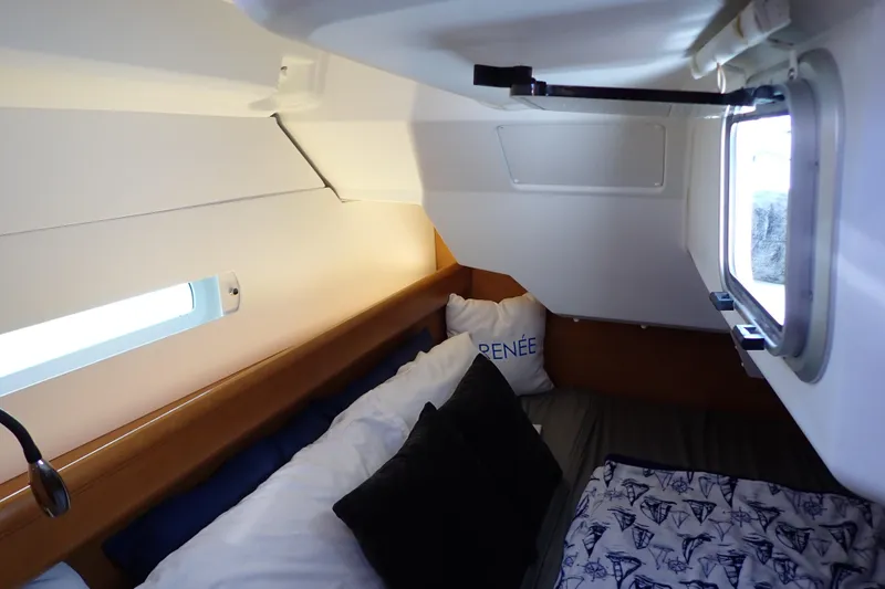 Slide: The Image of Cozy cabin interior of 2018 Jeanneau Sun Odyssey 389 sailboat with pillows and window. - 67