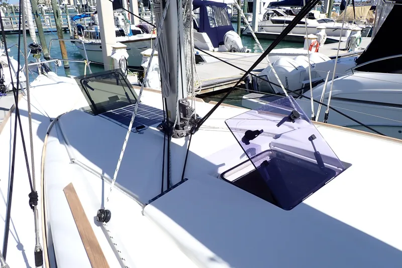 Slide: The Image of 2018 Jeanneau Sun Odyssey 389 sailboat deck with open hatches at marina. - 35