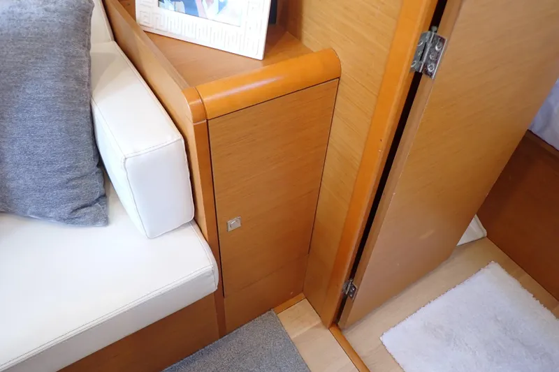Slide: The Image of Interior of 2018 Jeanneau Sun Odyssey 389 yacht with wooden cabinetry and white seating. - 120