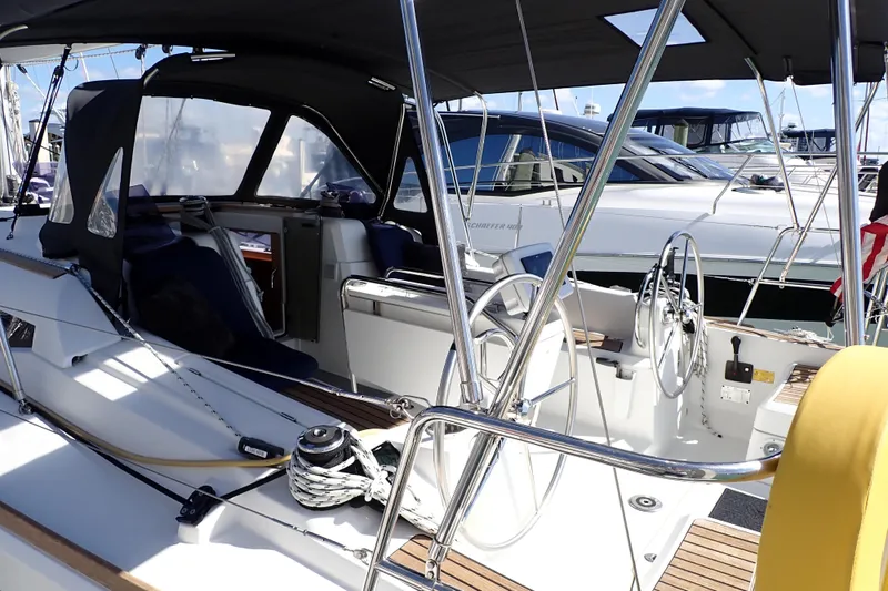 Slide: The Image of 2018 Jeanneau Sun Odyssey 389 sailboat cockpit with dual steering wheels and canopy. - 2