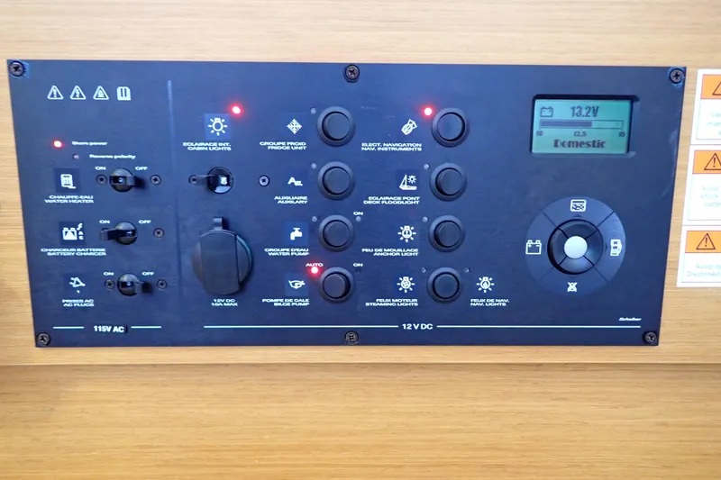Slide: The Image of Control panel of 2018 Jeanneau Sun Odyssey 389 sailboat, featuring various switches and indicators. - 52