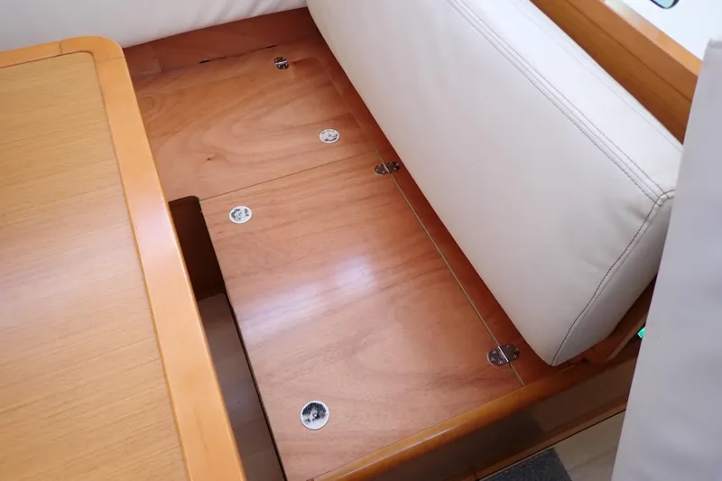 Slide: The Image of Interior view of 2018 Jeanneau Sun Odyssey 389 sailboat, featuring wooden flooring and white seating. - 135