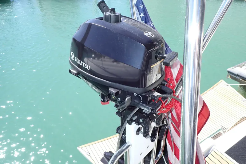 Slide: The Image of Tohatsu outboard motor on 2018 Jeanneau Sun Odyssey 389 sailboat, docked in clear water. - 18