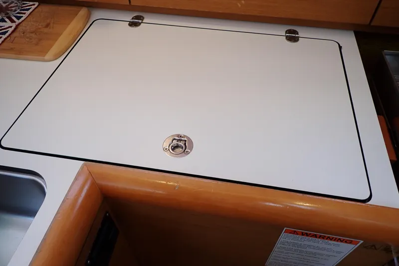Slide: The Image of Galley area of 2018 Jeanneau Sun Odyssey 389 sailboat with closed storage compartment. - 112