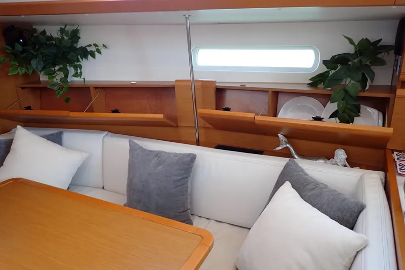 Slide: The Image of Interior of 2018 Jeanneau Sun Odyssey 389 yacht with cozy seating and decorative plants. - 125