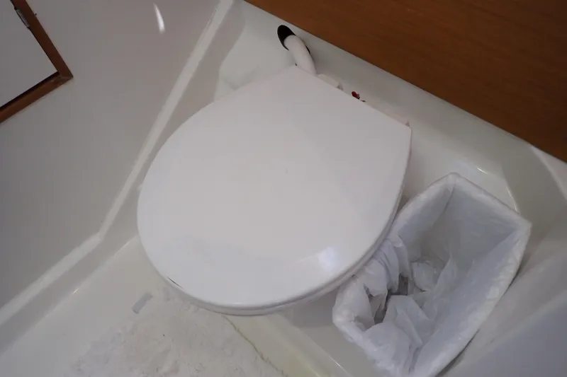 Slide: The Image of Toilet and trash bin in 2018 Jeanneau Sun Odyssey 389 yacht bathroom. - 177