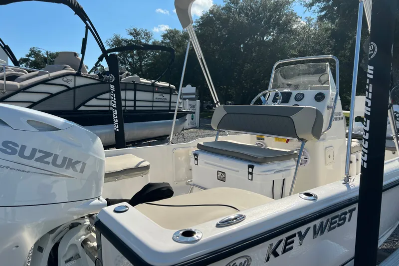 Slide: The Image of 2026 Key West 1720 Center Console boat with Suzuki engine, parked outdoors. - 13
