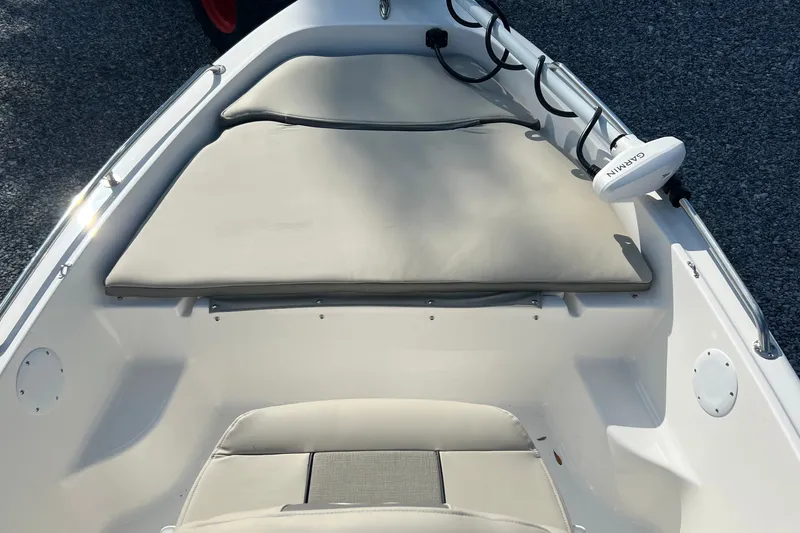 Slide: The Image of 2026 Key West 1720 Center Console boat interior with cushioned seating and Garmin equipment. - 9
