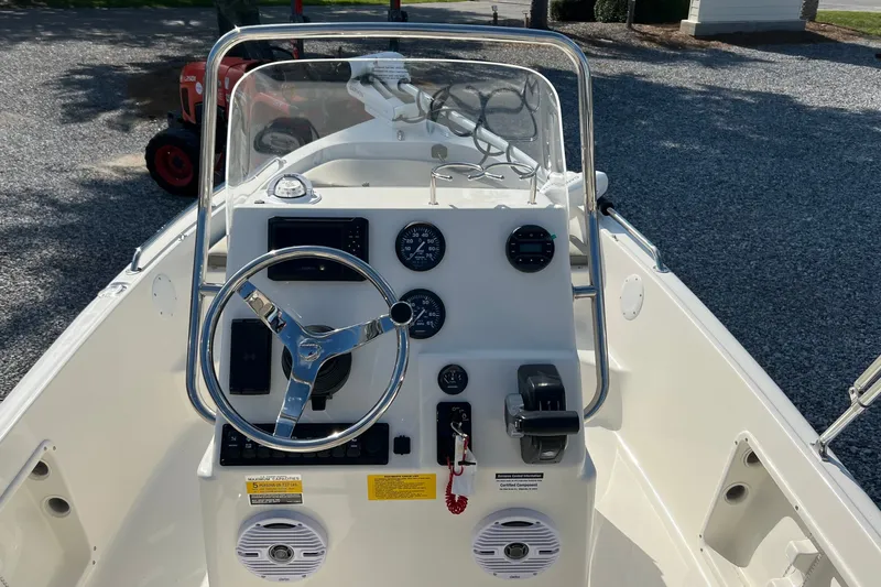Slide: The Image of 2026 Key West 1720 Center Console boat dashboard with steering wheel and gauges. - 11