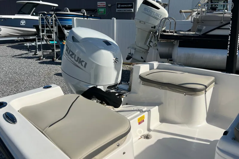 Slide: The Image of 2026 Key West 1720 Center Console boat with Suzuki outboard motor in a marina. - 14
