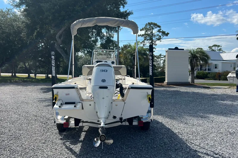 Slide: The Image of 2026 Key West 1720 Center Console boat with outboard motor, parked on gravel lot. - 3
