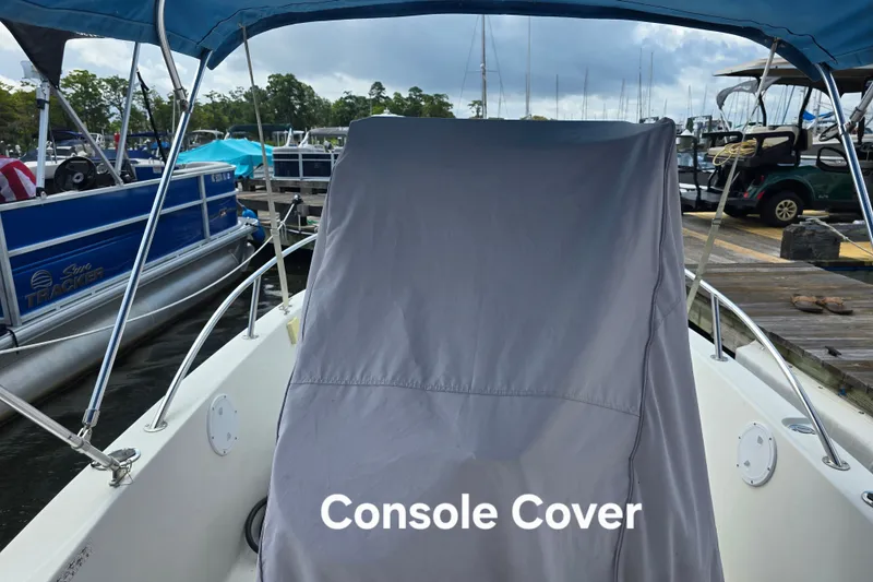 Slide: The Image of 2004 Sea Boss 180 Center Console boat with console cover at marina. - 8