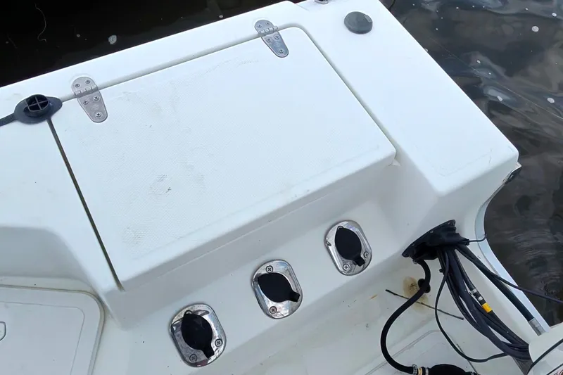 Slide: The Image of 2004 Sea Boss 180 Center Console boat deck with storage compartment and cable connections. - 19