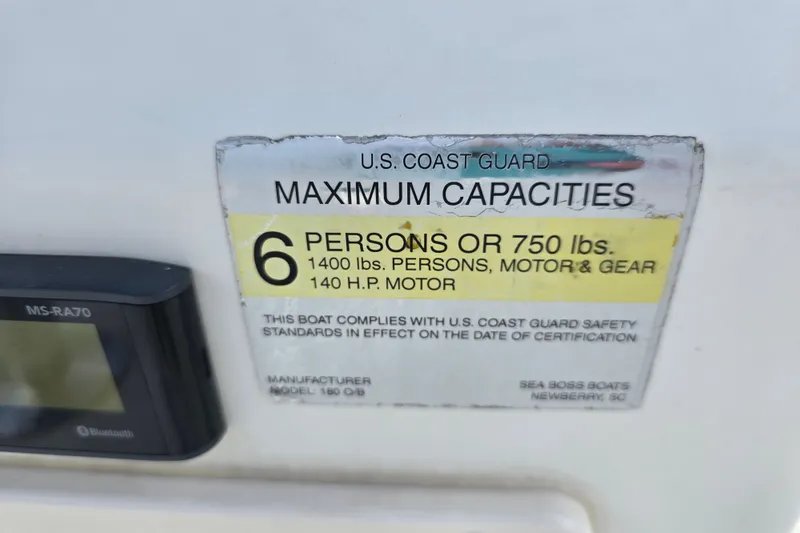 Slide: The Image of 2004 Sea Boss 180 Center Console capacity label, 6 persons or 750 lbs, 140 HP motor. - 27