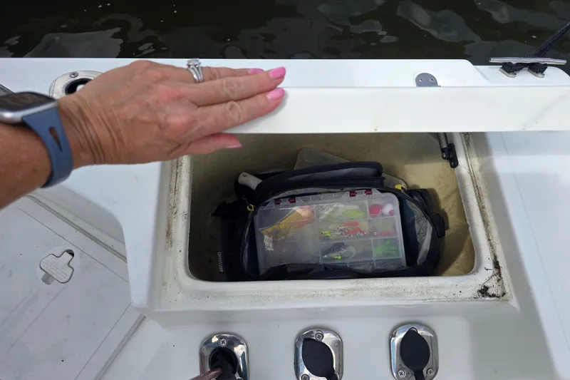 Slide: The Image of Hand opening storage compartment on 2004 Sea Boss 180 Center Console boat. - 15
