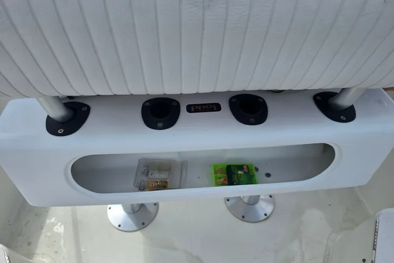 Slide: The Image of 2004 Sea Boss 180 Center Console boat seat with rod holders and storage compartment. - 22