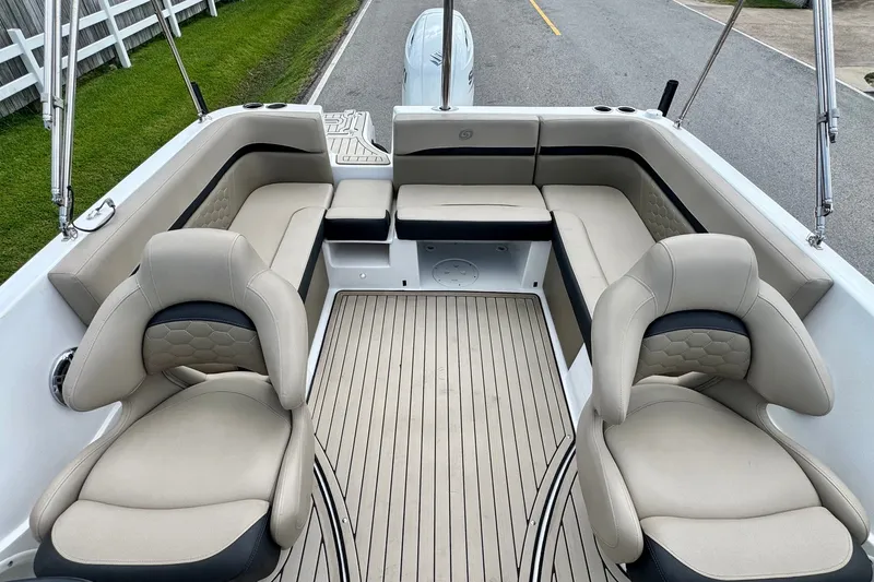 Slide: The Image of 2022 Hurricane Sundeck Sport 218 OB boat interior with beige seating and spacious layout. - 7