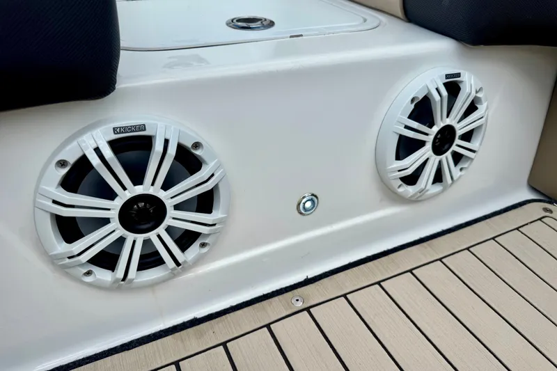 Slide: The Image of 2022 Hurricane Sundeck Sport 218 OB boat speakers on deck, featuring Kicker audio system. - 13
