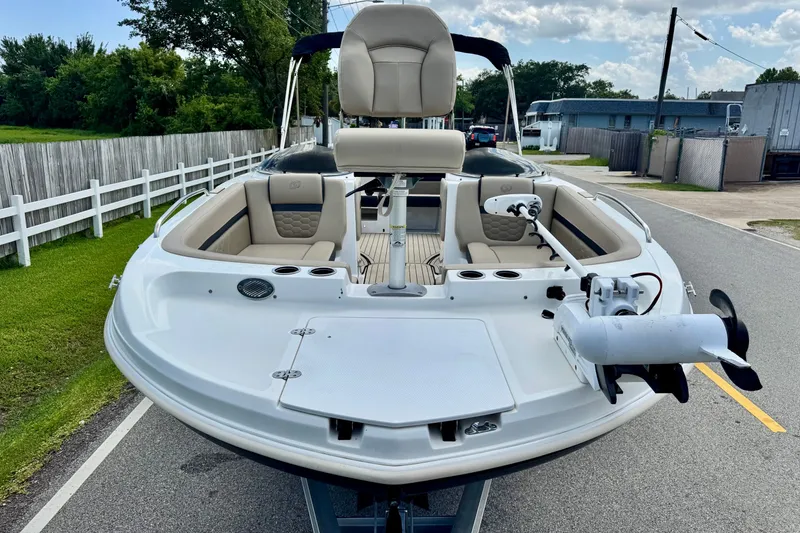 Slide: The Image of 2022 Hurricane Sundeck Sport 218 OB boat with beige seating and trolling motor. - 6
