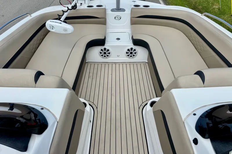 Slide: The Image of Interior view of 2022 Hurricane Sundeck Sport 218 OB boat with beige seating and wood flooring. - 10