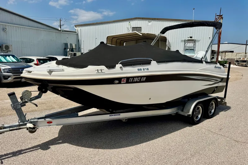 Slide: The Image of 2022 Hurricane Sundeck Sport 218 OB boat on trailer, covered and parked outdoors. - 14