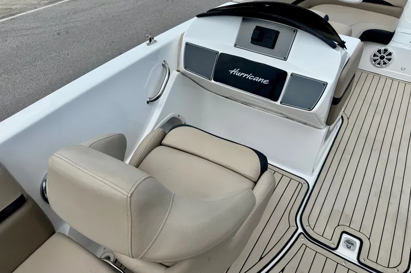 Slide: The Image of 2022 Hurricane Sundeck Sport 218 OB boat interior with beige seating and sleek dashboard. - 9
