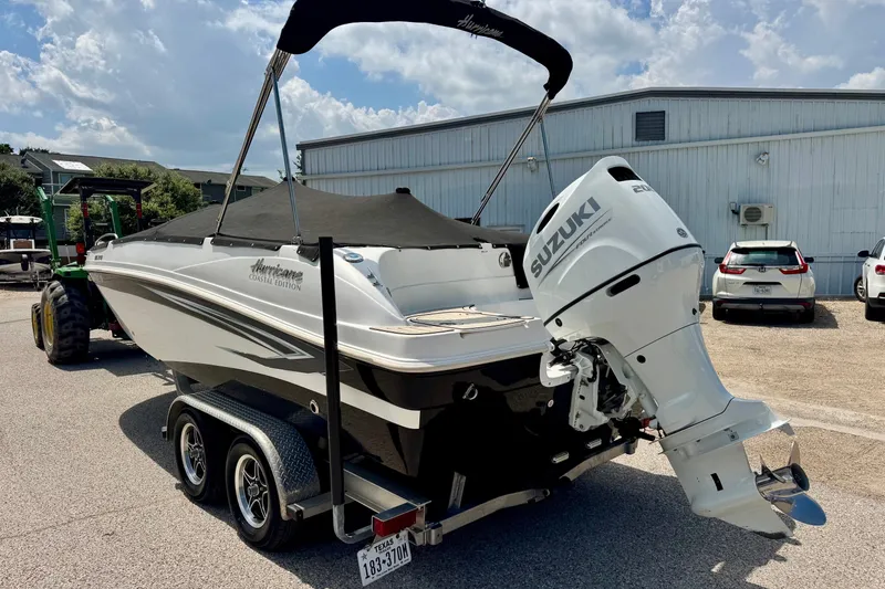 Slide: The Image of 2022 Hurricane Sundeck Sport 218 OB boat with Suzuki outboard motor on trailer. - 15