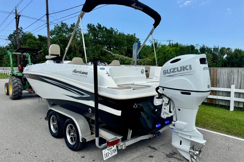 Slide: The Image of 2022 Hurricane Sundeck Sport 218 OB boat with Suzuki engine on trailer. - 2