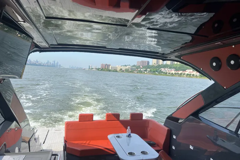 Slide: The Image of Luxurious 2024 Evolve 400HT yacht interior with red seating, cruising on open water. - 14