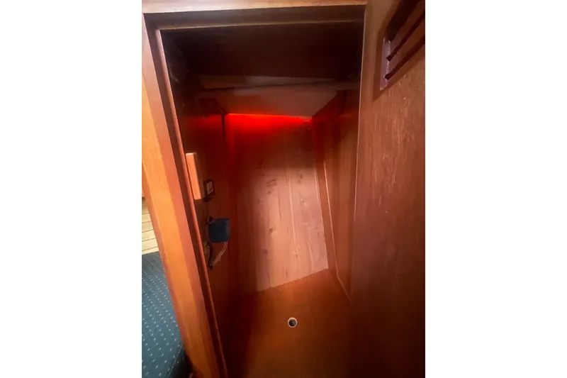 Slide: The Image of Interior view of 2001 Sabre 36 Express yacht with wooden paneling and red lighting. - 29