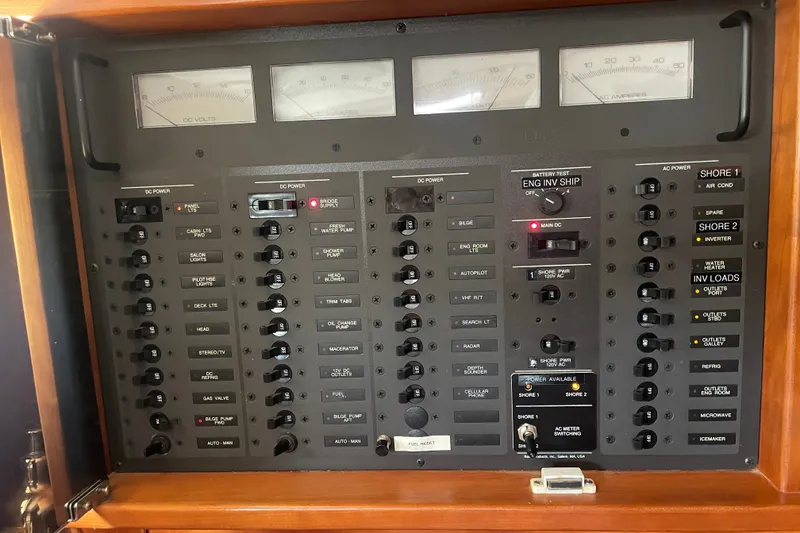 Slide: The Image of Electrical control panel of a 2001 Sabre 36 Express boat, featuring various switches and meters. - 21
